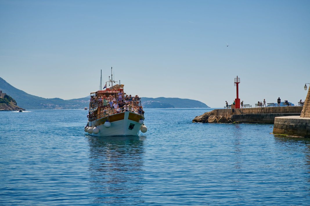 Adriana Cavtat boat tour ship cruising the Adriatic sea near Dubrovnik with passengers on deck.