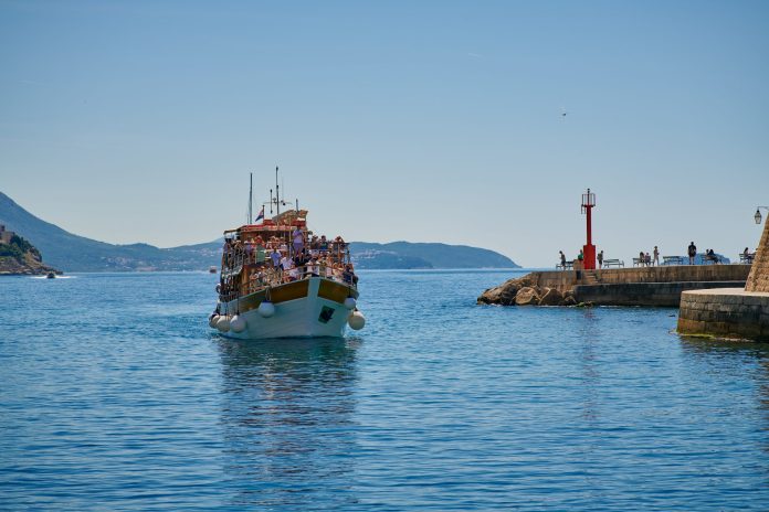 Adriana Cavtat boat tour ship cruising the Adriatic sea near Dubrovnik with passengers on deck.