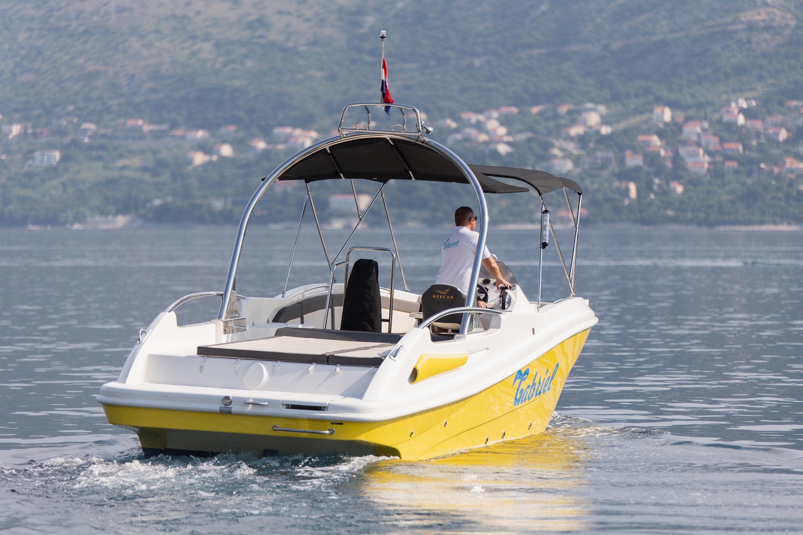 Private speedboat departing Cavtat over calm Adriatic water